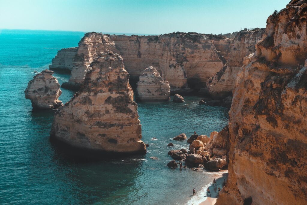 Explore the breathtaking rock formations and azure waters at Marinha Beach, Portugal.